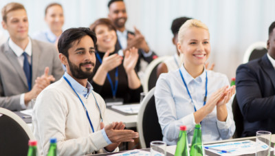 people applauding at business conference